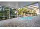 Screened outdoor pool surrounded by brick pavers, offering a private retreat at 4369 Marine Pkwy, New Port Richey, FL 34652