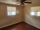 Bright bedroom featuring hardwood floors, ceiling fan, and natural light at 4534 Irene Loop, New Port Richey, FL 34652