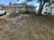 Cozy one story home with tan siding, large front yard, and mature trees at 4534 Irene Loop, New Port Richey, FL 34652