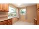 Cozy eat-in kitchen area with natural light provided by two large windows and view to the backyard at 5018 Sherwood Dr, New Port Richey, FL 34652