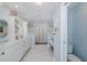 Spacious bathroom with a double vanity, walk-in shower, soaking tub, and coastal décor at 5040 Waterside Dr, Port Richey, FL 34668
