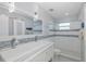 Modern bathroom with a large vanity, stylish mirrors, and a walk-in shower at 5040 Waterside Dr, Port Richey, FL 34668