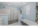 Stylized bathroom with a pebble tile shower, soaking tub, and decorative seashell accents at 5040 Waterside Dr, Port Richey, FL 34668