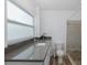 Bathroom features a spacious countertop, modern fixtures, and a stylish shower with river rock floor at 5040 Waterside Dr, Port Richey, FL 34668