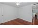 Bedroom with hardwood floors, a double closet, ceiling fan and an entry door at 5040 Waterside Dr, Port Richey, FL 34668