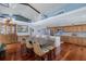 Open-concept dining area featuring high ceilings, cherry wood floors, and a long wood table with seating for eight at 5040 Waterside Dr, Port Richey, FL 34668