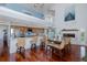 Open-concept dining room with fireplace, island seating, and hardwood floors at 5040 Waterside Dr, Port Richey, FL 34668