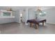Large game room features a pool table, wet bar, and access to the outdoors at 5040 Waterside Dr, Port Richey, FL 34668