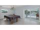 Game room with a pool table and a sliding glass door leading to a pool at 5040 Waterside Dr, Port Richey, FL 34668