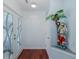 Charming hallway entrance with decorative glass door, cherry wood floors, and a whimsical nautical theme at 5040 Waterside Dr, Port Richey, FL 34668