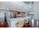 Modern kitchen boasts stainless steel appliances, island with barstool seating, and wood floors with access to the outside patio at 5040 Waterside Dr, Port Richey, FL 34668