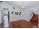 Cozy living room offers cherry wood floors, white walls, and a staircase leading to the upper level at 5040 Waterside Dr, Port Richey, FL 34668