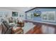 Cozy living room with vaulted ceilings, wood beams, and lots of natural light at 5040 Waterside Dr, Port Richey, FL 34668