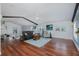 Spacious living room with wood floors, ceiling fan, and a glass railed loft at 5040 Waterside Dr, Port Richey, FL 34668