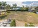 Large grassy vacant lot perfect for building, complete with boat trailer and gravel bed along canal at 5040 Waterside Dr, Port Richey, FL 34668