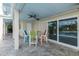 Covered outdoor dining area with ceiling fan and views of the pool at 5040 Waterside Dr, Port Richey, FL 34668