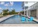Gorgeous waterfront pool with lounge chairs and covered patio area for entertaining at 5040 Waterside Dr, Port Richey, FL 34668