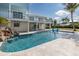 Stunning waterfront pool with cascading waterfall feature and ample lounging space at 5040 Waterside Dr, Port Richey, FL 34668