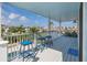 Inviting porch with stylish stools under the blue sky with neighborhood views and glimpses of the pool at 5040 Waterside Dr, Port Richey, FL 34668