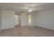 Neutral bedroom featuring a ceiling fan and doorways to the bathroom and hallway at 5931 Precious View Ct, New Port Richey, FL 34655