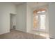 Bright foyer features tile flooring, a chandelier, and a decorative glass double door entrance at 5931 Precious View Ct, New Port Richey, FL 34655