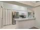 Contemporary kitchen with stainless steel appliances, breakfast bar, and white cabinetry at 5931 Precious View Ct, New Port Richey, FL 34655