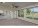 Living room features a partial view of the kitchen, with expansive windows overlooking a vibrant green lawn at 5931 Precious View Ct, New Port Richey, FL 34655