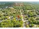 A high aerial view of the home shows proximity to Downtown Brooksville and surrounding mature trees and neighborhood at 606 Howell Ave, Brooksville, FL 34601
