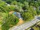 Aerial view of home with screened pool and surrounding trees at 606 Howell Ave, Brooksville, FL 34601