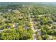 A neighborhood aerial view showcases the mature trees and proximity to nearby schools, businesses, and downtown Brooksville at 606 Howell Ave, Brooksville, FL 34601