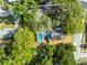 Aerial view of home showcasing the pool, landscaping, and surrounding neighborhood at 606 Howell Ave, Brooksville, FL 34601