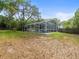 View of the screened in pool from the backyard at 606 Howell Ave, Brooksville, FL 34601