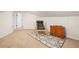 Cozy basement space with neutral walls, a unique chair, decorative rug, and wooden cabinet at 606 Howell Ave, Brooksville, FL 34601
