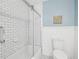 Modern bathroom featuring white subway tile and stylish black and white patterned floors at 606 Howell Ave, Brooksville, FL 34601