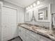 Bathroom featuring double sink with granite countertops, white cabinets, and modern fixtures at 606 Howell Ave, Brooksville, FL 34601