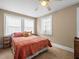 Sunlit bedroom with a comfy bed, two windows, and wooden bedside tables at 606 Howell Ave, Brooksville, FL 34601