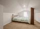 This carpeted bedroom features a bright window, a column and a full-sized bed at 606 Howell Ave, Brooksville, FL 34601