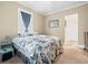 Inviting bedroom with plush bed, window with blue curtains, and closet for storage at 606 Howell Ave, Brooksville, FL 34601