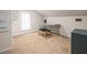 This carpeted bonus room features a bright window and a desk at 606 Howell Ave, Brooksville, FL 34601