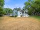 Inviting home with a well-maintained lawn, mature trees, and charming front porch, enhancing the property's curb appeal at 606 Howell Ave, Brooksville, FL 34601