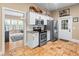 Galley kitchen featuring stainless steel appliances, white cabinets, and a subway tile backsplash at 606 Howell Ave, Brooksville, FL 34601