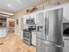Kitchen view showcasing stainless steel refrigerator, range, and breakfast bar with view into the dining area at 606 Howell Ave, Brooksville, FL 34601