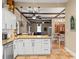 Open kitchen boasts granite countertops, white cabinetry, and an open concept to the living and dining areas at 606 Howell Ave, Brooksville, FL 34601