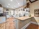 View of the kitchen from the breakfast nook featuring stainless appliances, white cabinets, and access to laundry room at 606 Howell Ave, Brooksville, FL 34601