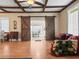 Living room featuring barn doors, hardwood floors, and ample natural light at 606 Howell Ave, Brooksville, FL 34601