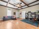 Comfortable living room with a black couch, hardwood floors, and a bookshelf at 606 Howell Ave, Brooksville, FL 34601