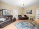 Inviting living room featuring leather sofas, hardwood floors, a decorative rug, and bright natural light at 606 Howell Ave, Brooksville, FL 34601