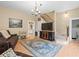 Charming living room with hardwood floors, decorative rug, comfortable seating, and seamless access to kitchen at 606 Howell Ave, Brooksville, FL 34601