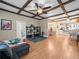 Open-concept living area with hardwood floors, ceiling fan, and view to the dining and kitchen at 606 Howell Ave, Brooksville, FL 34601
