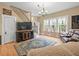 Spacious living room boasts a large window, hardwood floors, comfortable seating and a decorative rug at 606 Howell Ave, Brooksville, FL 34601